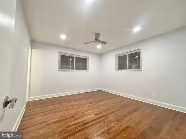 a view of a room with wooden floor and window