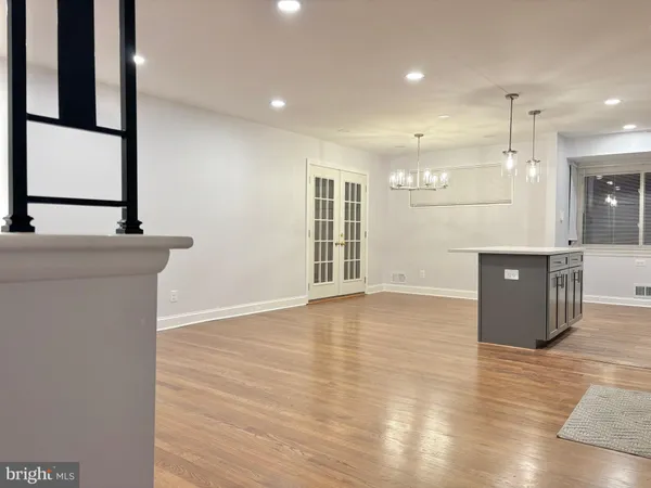 a view of a kitchen with wooden floor and a sink