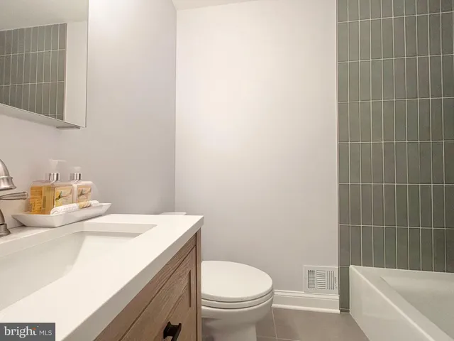 a bathroom with a sink a toilet and bathtub