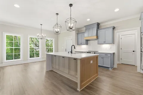 a kitchen with a sink window and cabinets