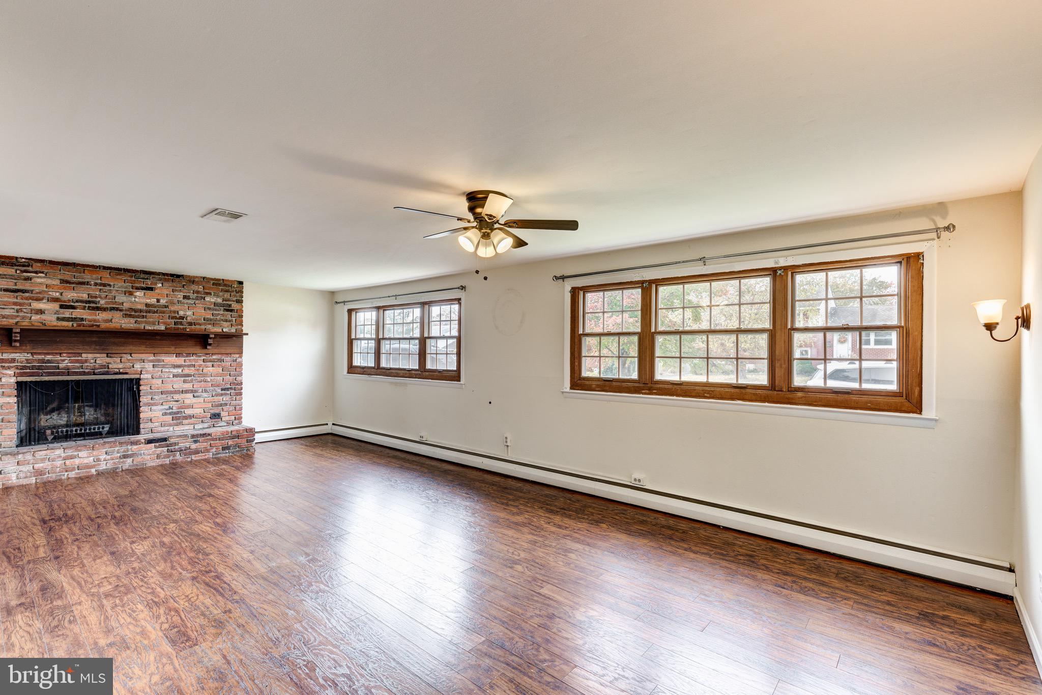 2119 Eastridge Road Lutherville-Timonium, MD 21093 - Photo 15 of 39 an empty room with wooden floor fireplace and windows
