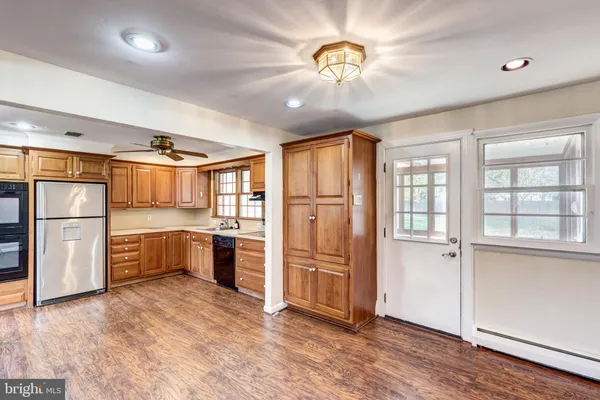 a large kitchen with cabinets and stainless steel appliances
