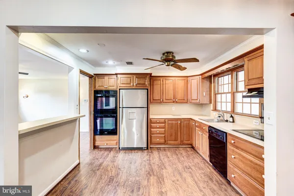 a kitchen with stainless steel appliances granite countertop a refrigerator and a sink