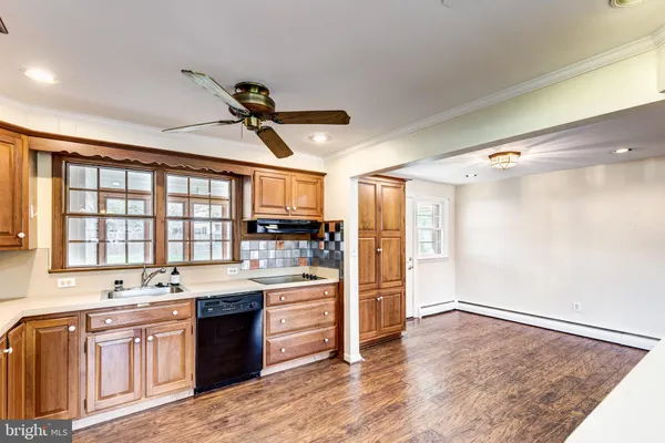 a large kitchen with kitchen island a sink stainless steel appliances and cabinets