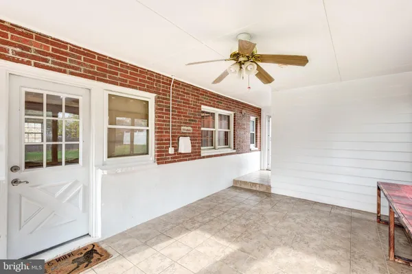 a view of a livingroom with a ceiling fan and window