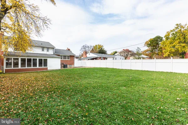 a view of a house with a yard and sitting area