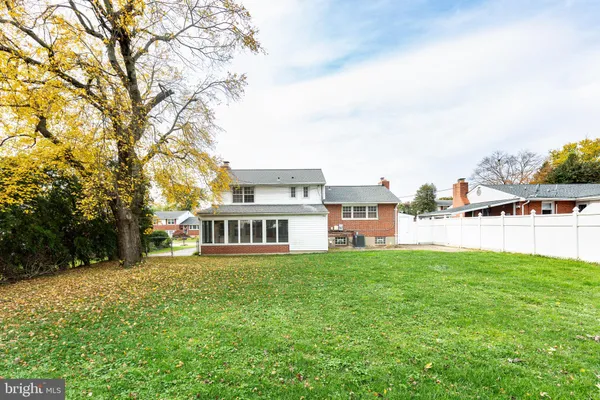 a view of a house with a yard and sitting area