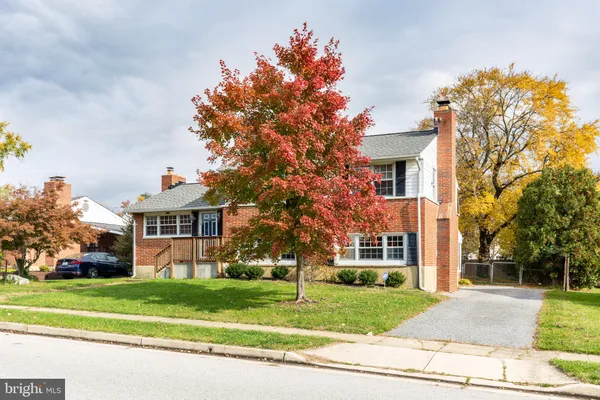 a front view of a house with a yard and a garage