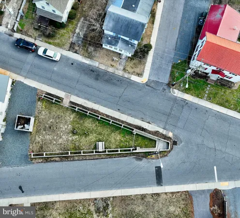 an aerial view of a residential houses with outdoor space