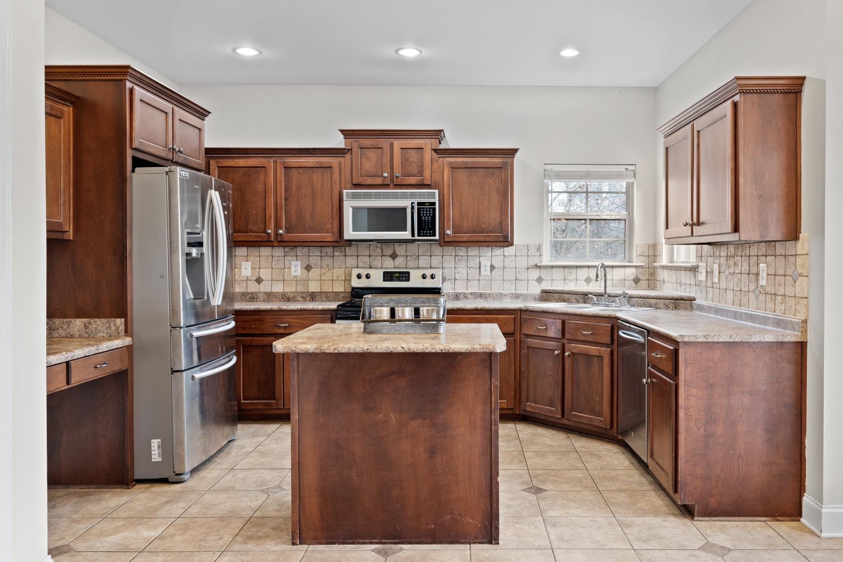 8169 Miller Road Atoka, TN 38004 - Photo 21 of 40 a kitchen with stainless steel appliances granite countertop a stove top oven a sink dishwasher a refrigerator and a oven