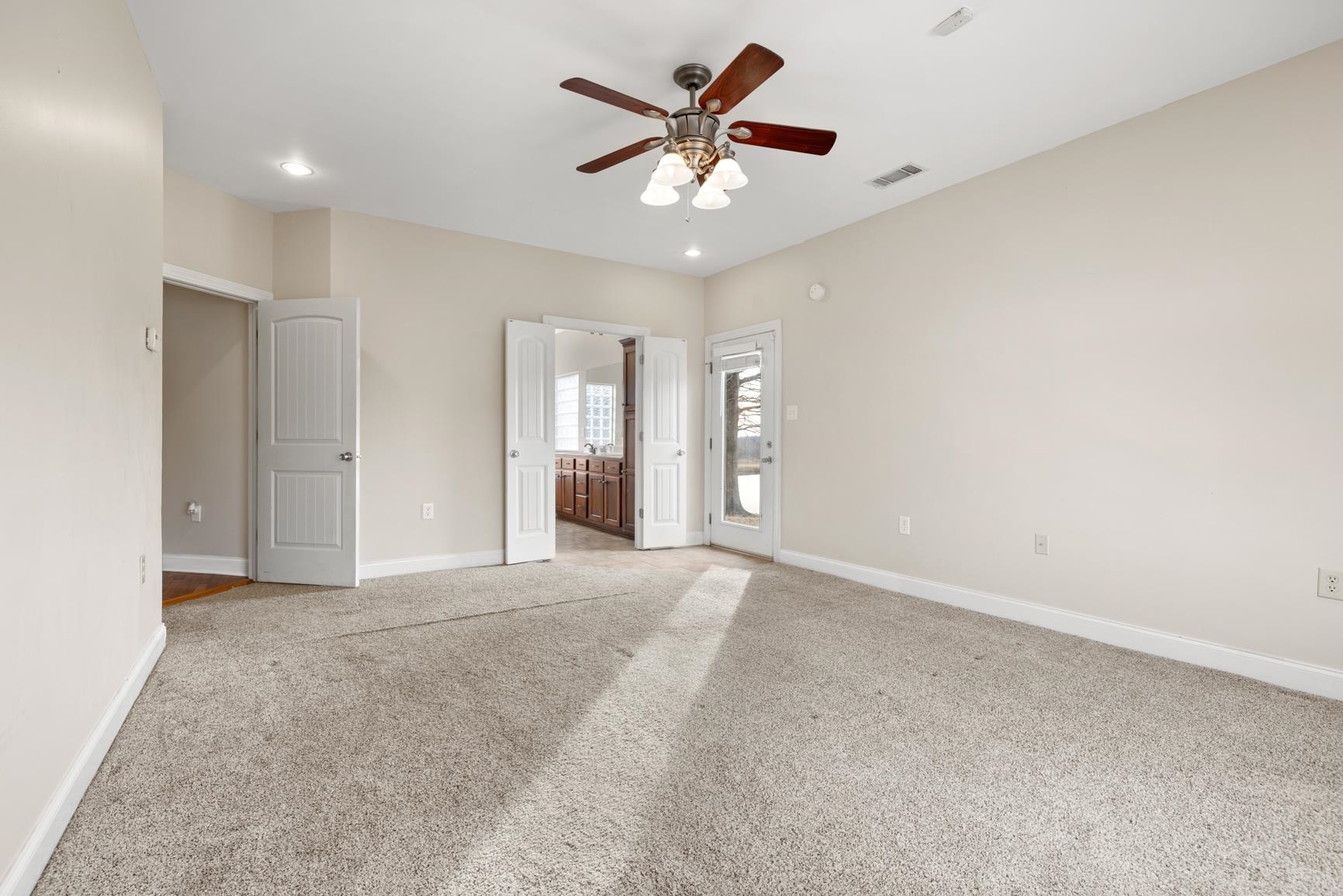 8169 Miller Road Atoka, TN 38004 - Photo 25 of 40 an empty room with chandelier fan and windows