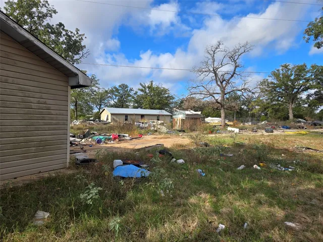 a backyard of a house with table and chairs