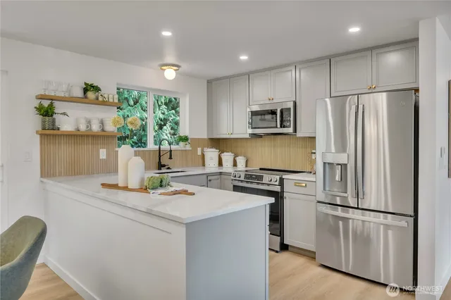 a kitchen with a sink stove and refrigerator