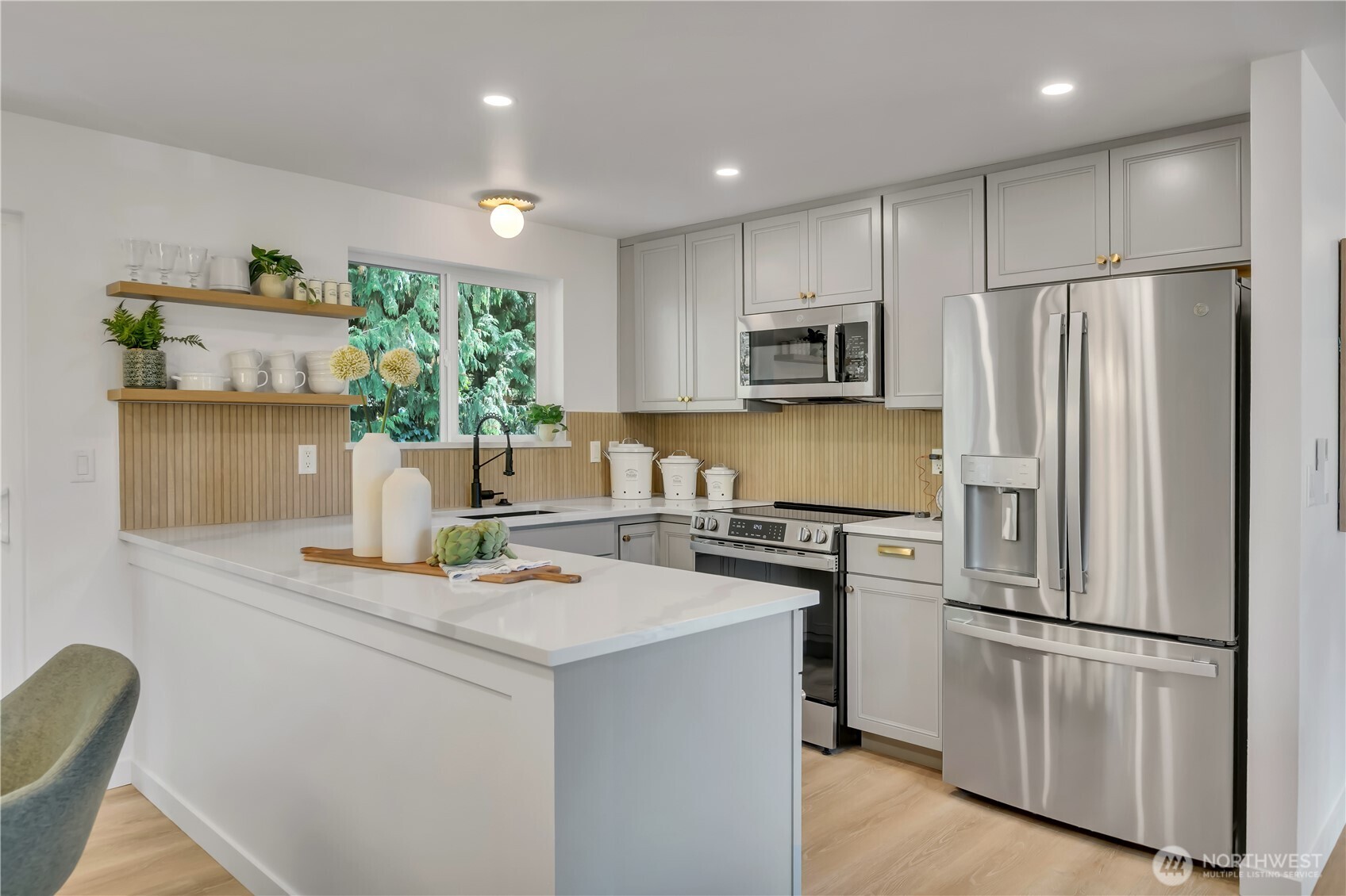 2310 Aberdeen Avenue Northeast Renton, WA 98056 - Photo 12 of 35 a kitchen with kitchen island a stove a refrigerator and a refrigerator