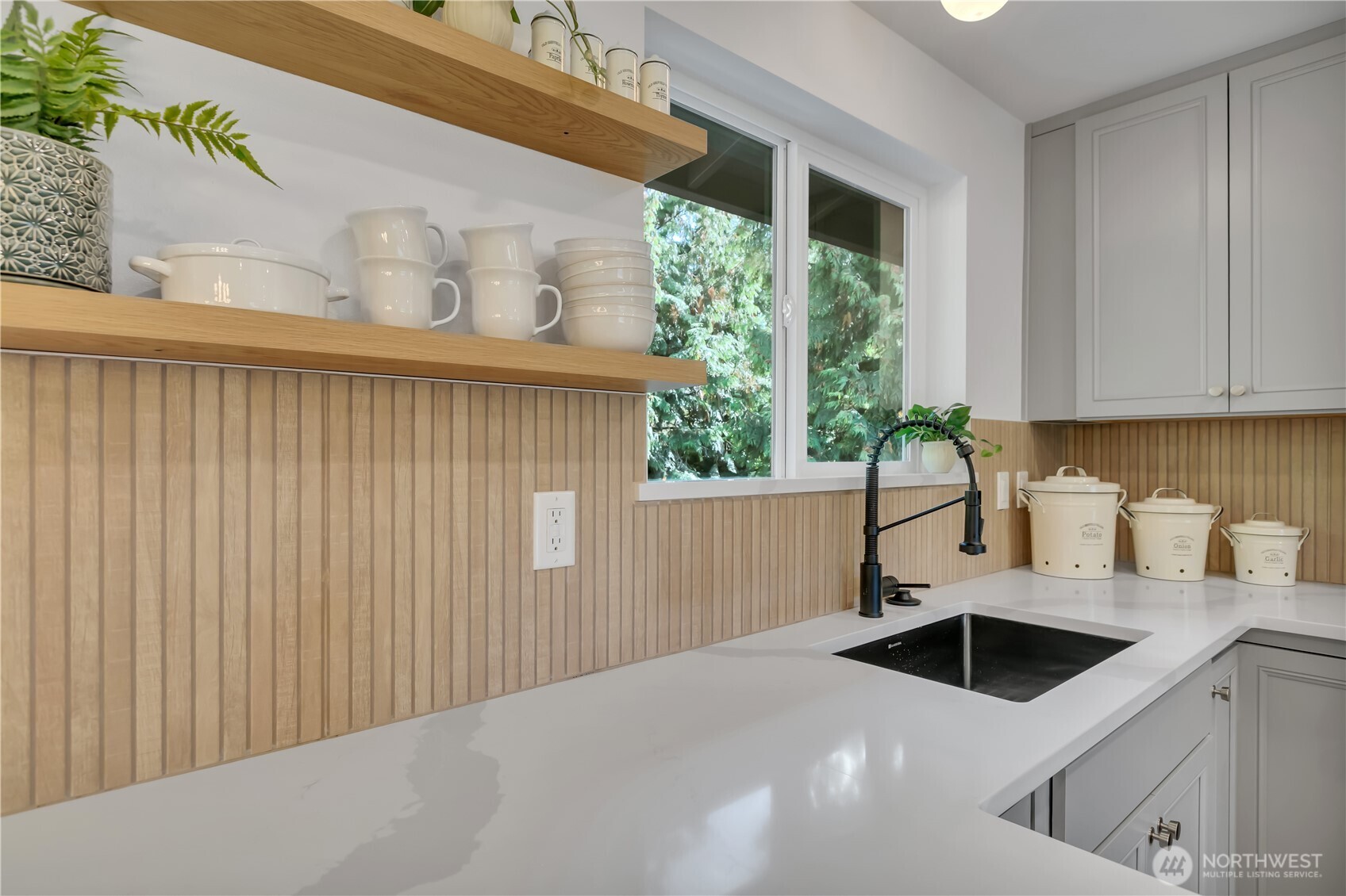 2310 Aberdeen Avenue Northeast Renton, WA 98056 - Photo 14 of 35 a kitchen with a sink a kitchen island a stove and a window
