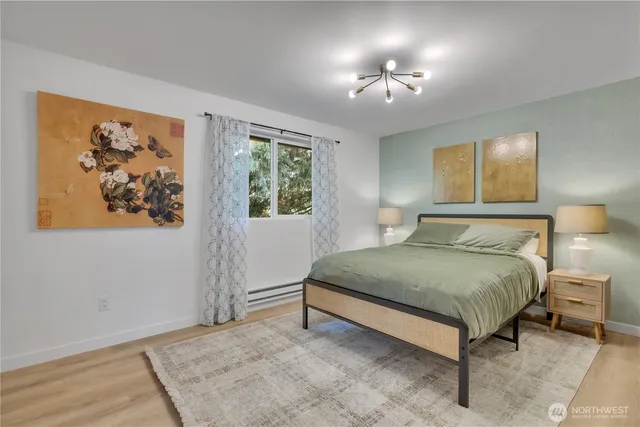 a bedroom with a bed and a chandelier