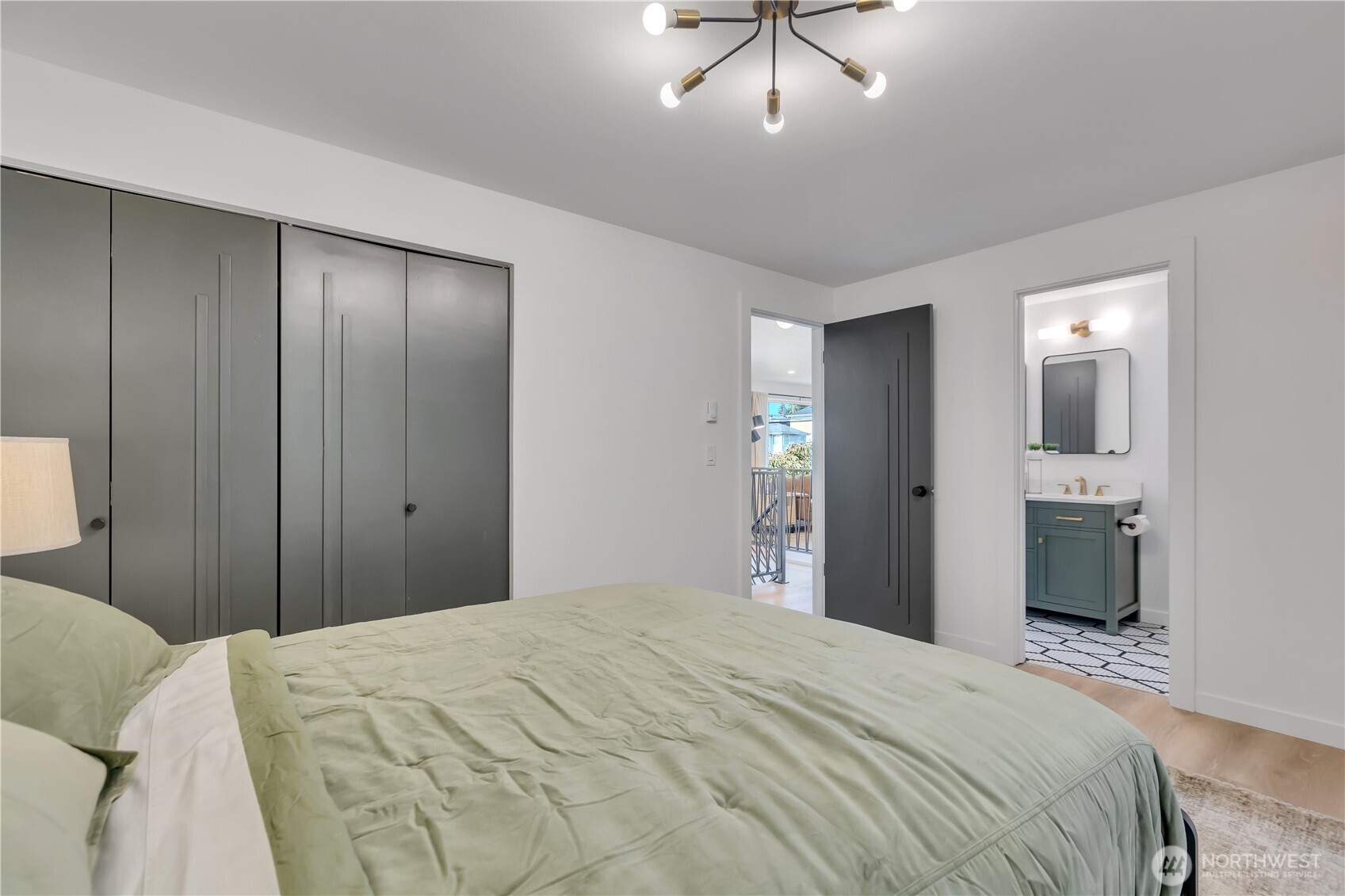 2310 Aberdeen Avenue Northeast Renton, WA 98056 - Photo 16 of 35 a bedroom with a bed and a chandelier