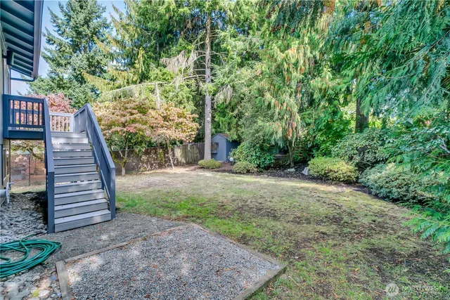 a view of a house with a yard and tree s