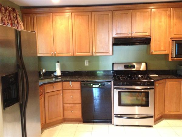 84 Seaver Street Wellesley, MA 02481 - Photo 3 of 13 a kitchen with stainless steel appliances granite countertop a stove a refrigerator and a sink