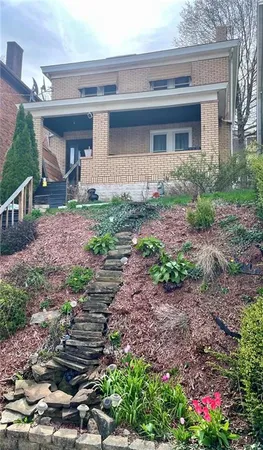 a front view of a house with garden