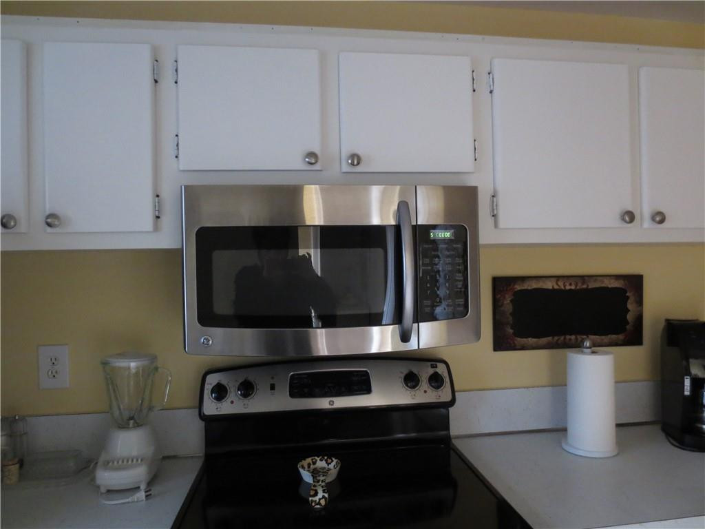 8822 West McNab Road, Unit 205 Tamarac, FL 33321 - Photo 1 of 20 a living room with a stove and a microwave