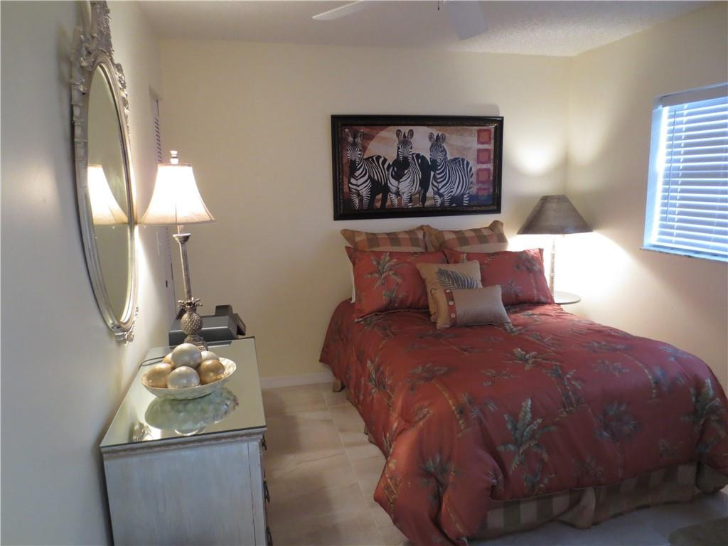 8822 West McNab Road, Unit 205 Tamarac, FL 33321 - Photo 12 of 20 a bedroom with a bed and a painting on the wall