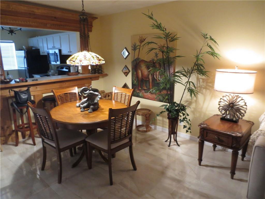 8822 West McNab Road, Unit 205 Tamarac, FL 33321 - Photo 15 of 20 a kitchen with a table and chairs in it