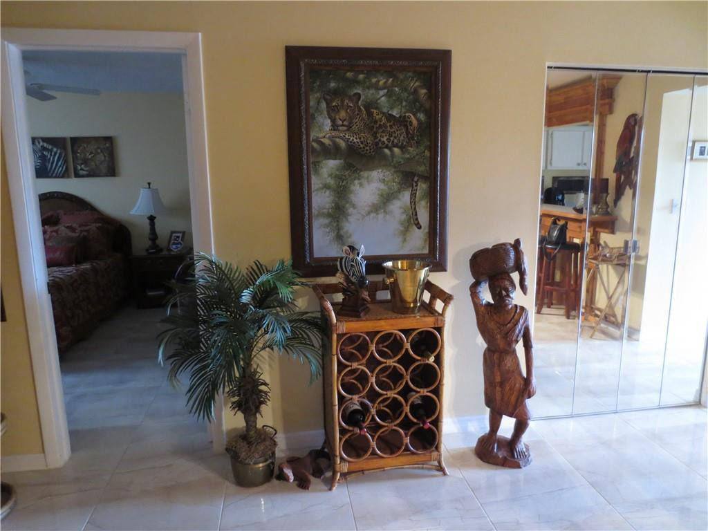 8822 West McNab Road, Unit 205 Tamarac, FL 33321 - Photo 16 of 20 a living room with furniture a lamp and a potted plant