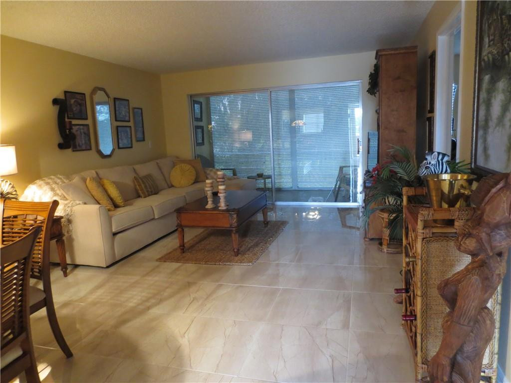 8822 West McNab Road, Unit 205 Tamarac, FL 33321 - Photo 17 of 20 a living room with furniture and a large window