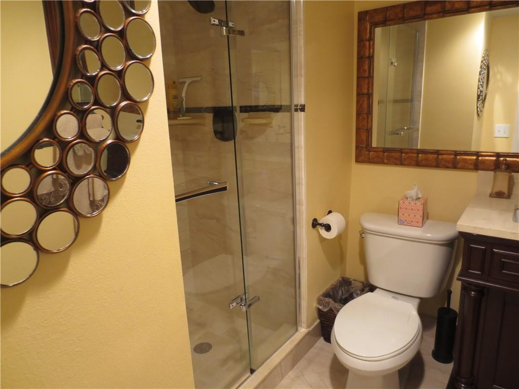8822 West McNab Road, Unit 205 Tamarac, FL 33321 - Photo 18 of 20 a white toilet sitting next to a bathroom sink