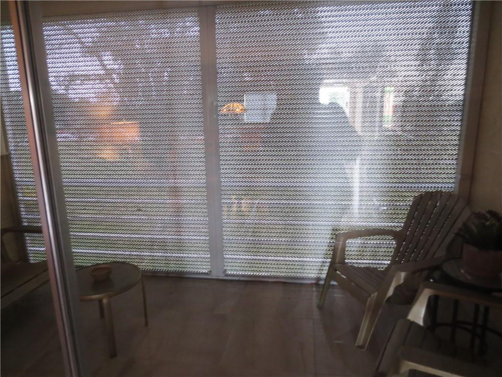 8822 West McNab Road, Unit 205 Tamarac, FL 33321 - Photo 6 of 20 a view of a chair near a window