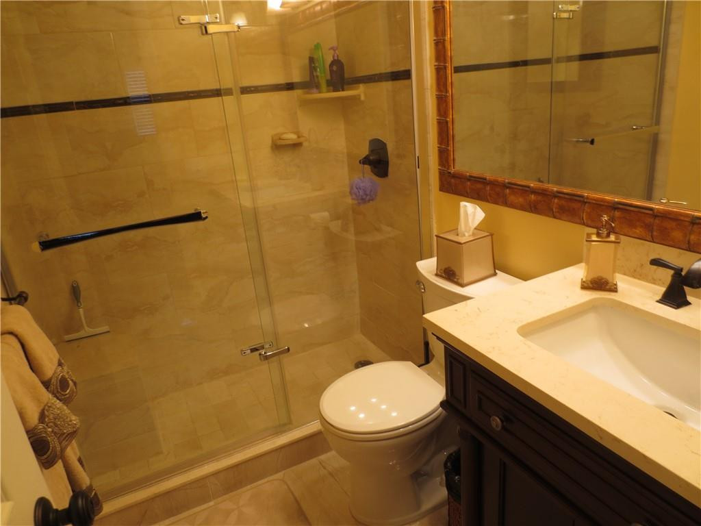 8822 West McNab Road, Unit 205 Tamarac, FL 33321 - Photo 9 of 20 a bathroom with a sink a toilet and shower