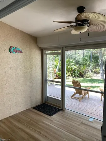 a view of a room with a window and wooden floor