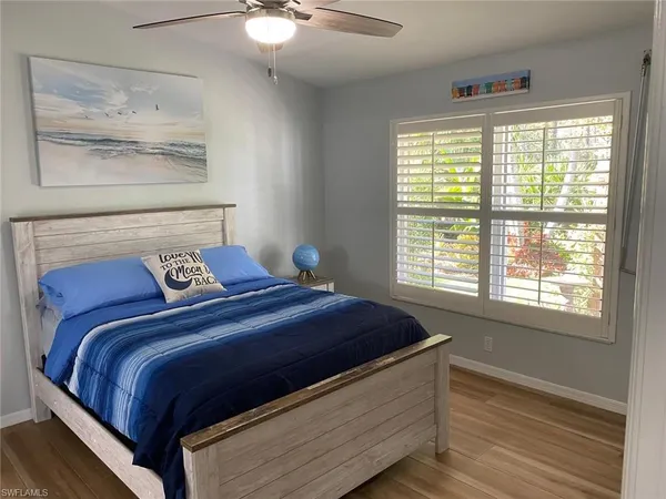 a bedroom with a bed and a painting on the wall