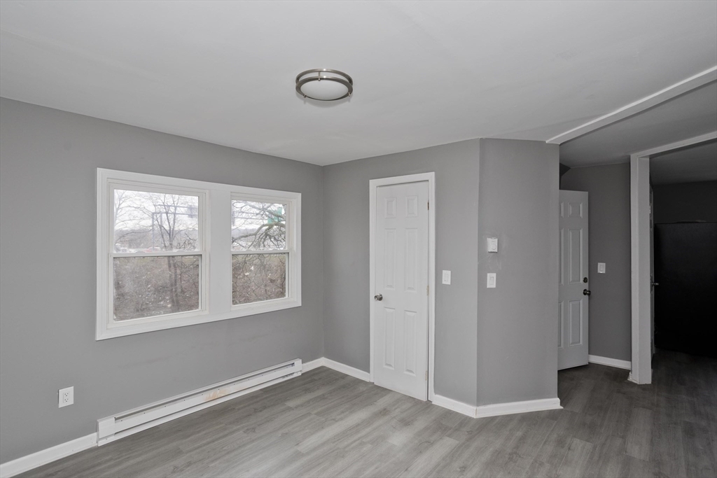 44 Eagle Street Springfield, MA 01107 - Photo 13 of 38 a view of an empty room with wooden floor and a window