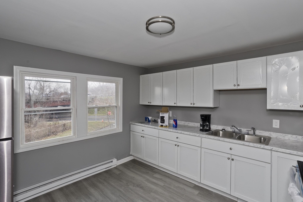 44 Eagle Street Springfield, MA 01107 - Photo 16 of 38 a kitchen with appliances cabinets a sink and a window