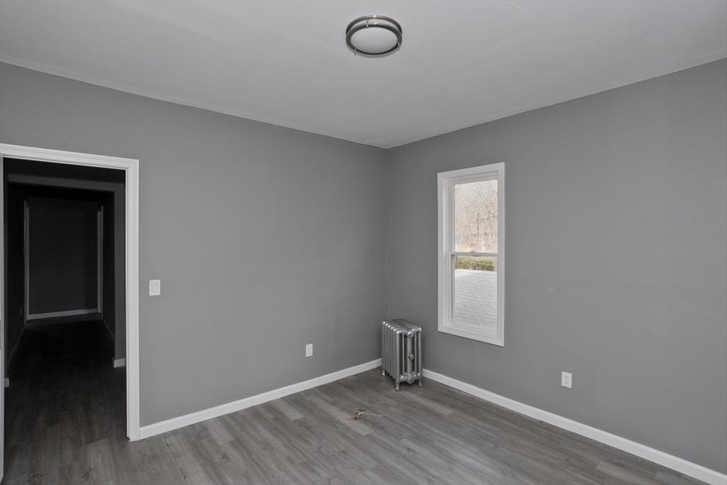 44 Eagle Street Springfield, MA 01107 - Photo 18 of 38 an empty room with wooden floor and windows