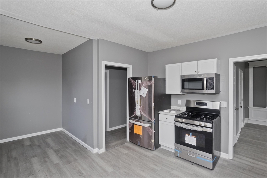 44 Eagle Street Springfield, MA 01107 - Photo 22 of 38 a kitchen with stainless steel appliances a refrigerator and a stove top oven