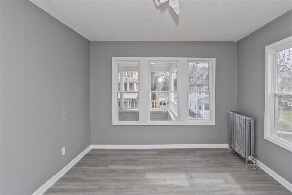 44 Eagle Street Springfield, MA 01107 - Photo 26 of 38 an empty room with wooden floor and windows