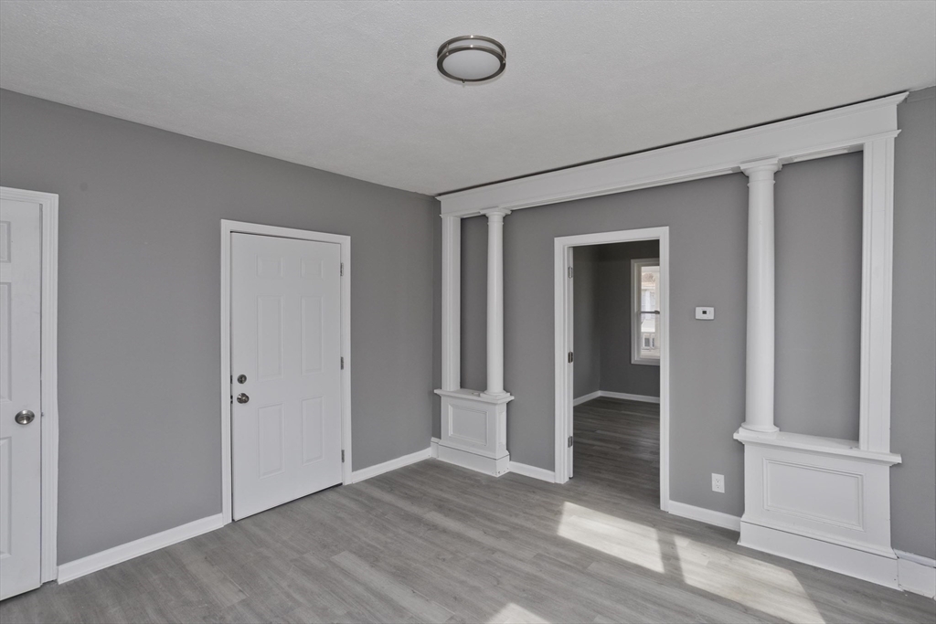 44 Eagle Street Springfield, MA 01107 - Photo 27 of 38 an empty room with wooden floor and windows