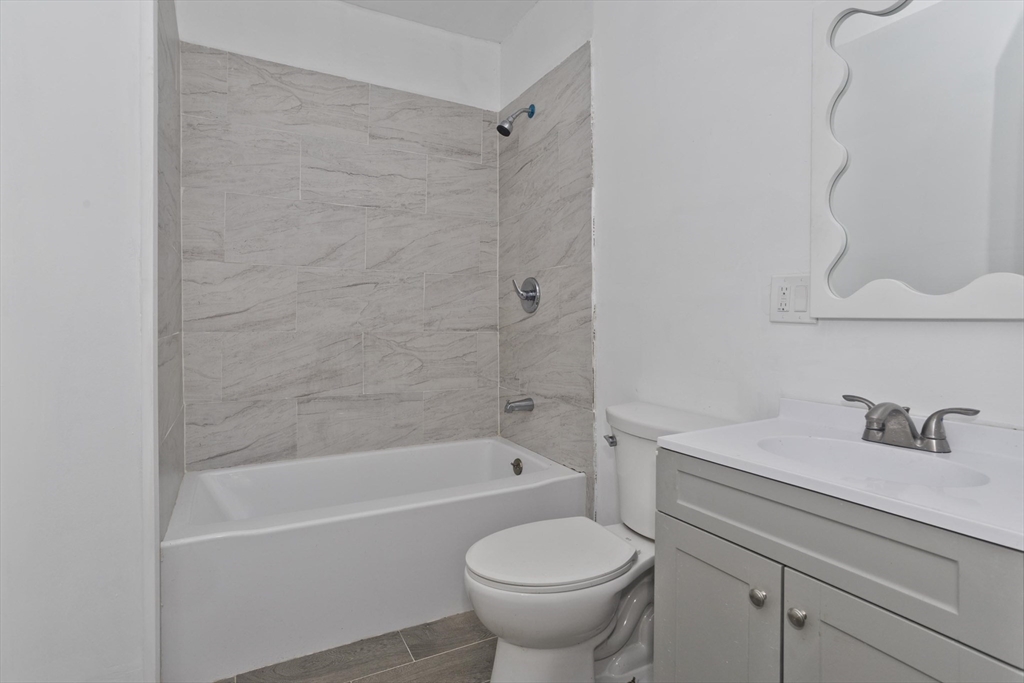 44 Eagle Street Springfield, MA 01107 - Photo 31 of 38 a bathroom with a sink a toilet and a bathtub