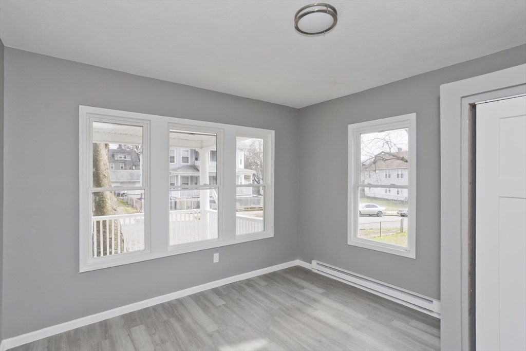 44 Eagle Street Springfield, MA 01107 - Photo 35 of 38 a view of an empty room with a window and wooden floor