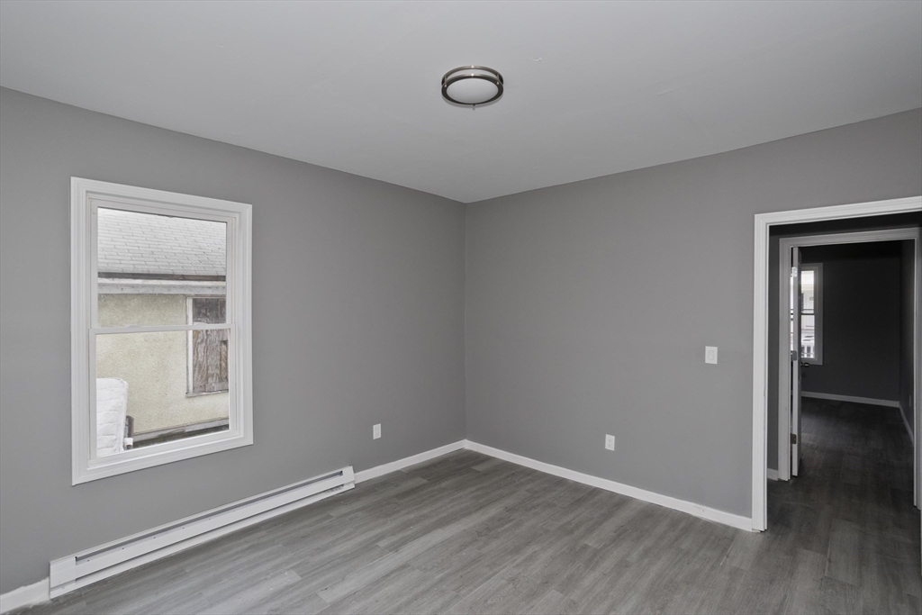 44 Eagle Street Springfield, MA 01107 - Photo 36 of 38 an empty room with wooden floor and windows