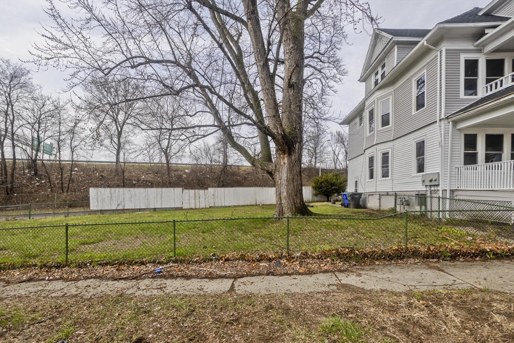 44 Eagle Street Springfield, MA 01107 - Photo 5 of 38 a view of a house with a yard and a large tree