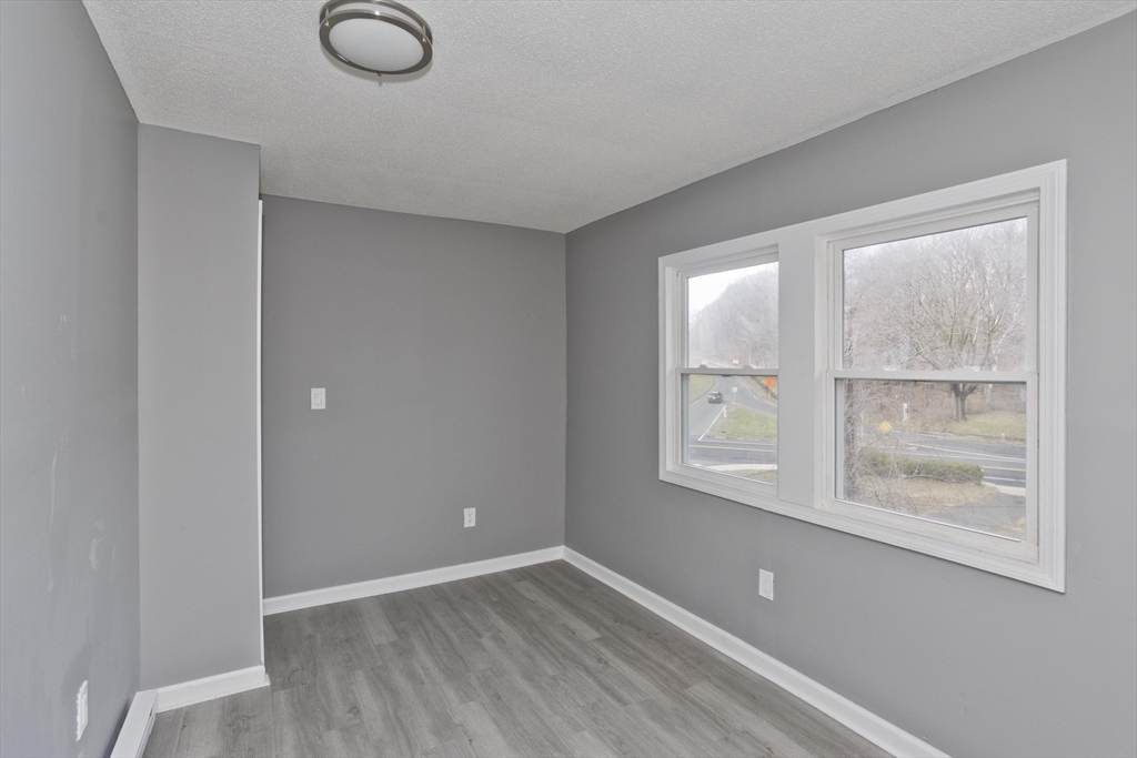 44 Eagle Street Springfield, MA 01107 - Photo 8 of 38 a view of an empty room with wooden floor and a window