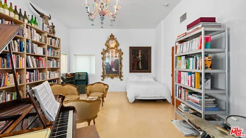 a living room with furniture and a book shelf