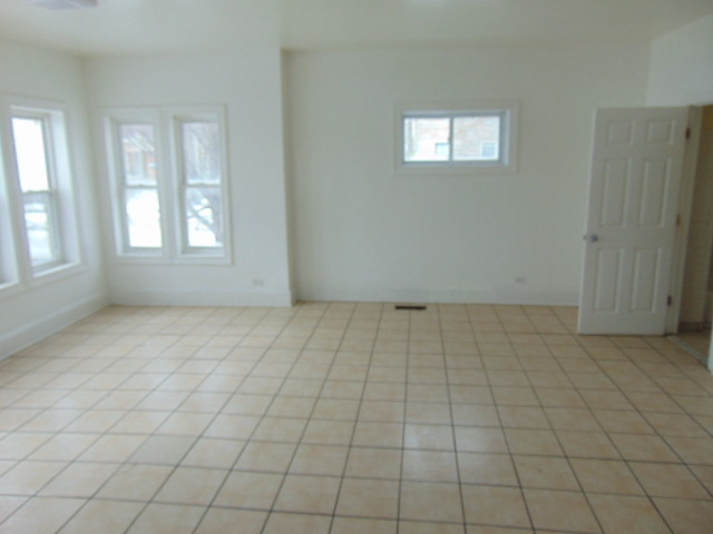 1 East 114th Street Chicago, IL 60628 - Photo 3 of 12 an empty room with windows