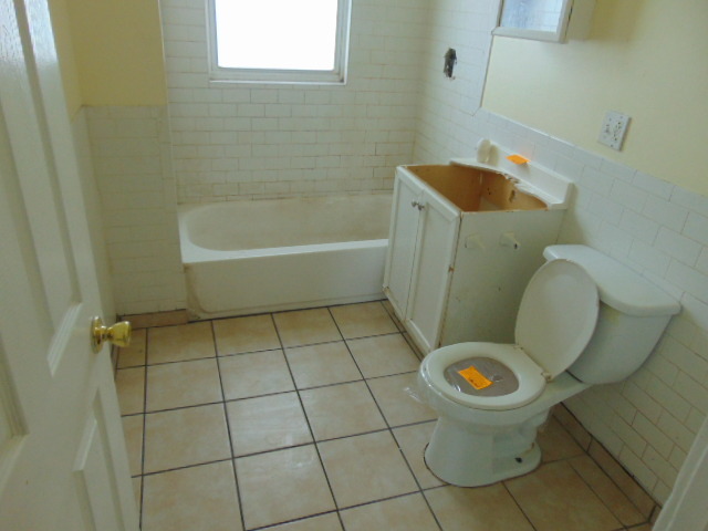 1 East 114th Street Chicago, IL 60628 - Photo 10 of 12 a bathroom with a sink and toilet