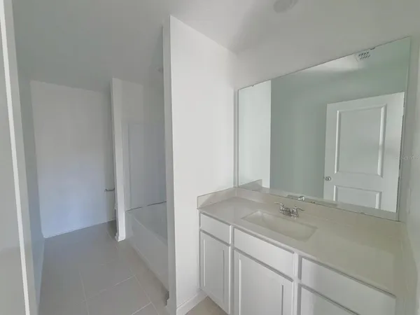 a bathroom with a sink and vanity