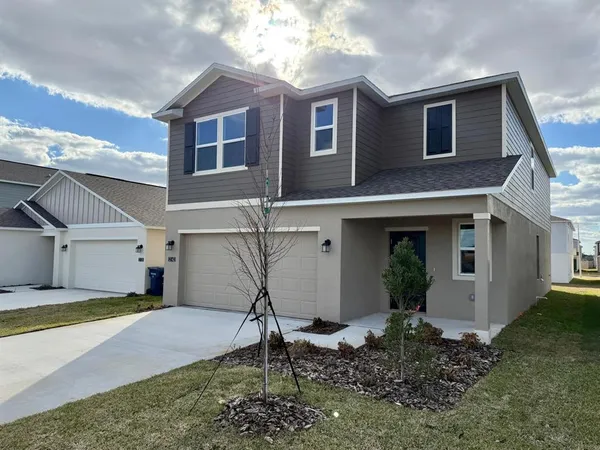 a house that has a tree in front of the house